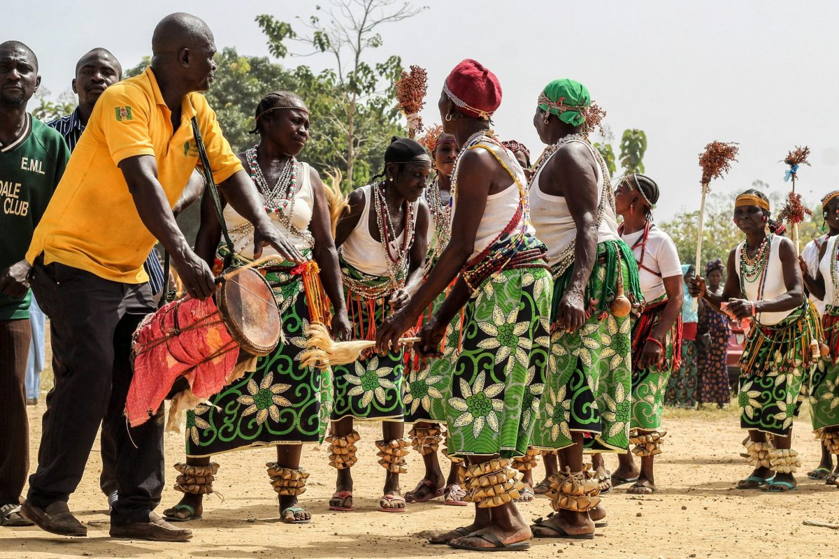 African men and women dancing in the public.